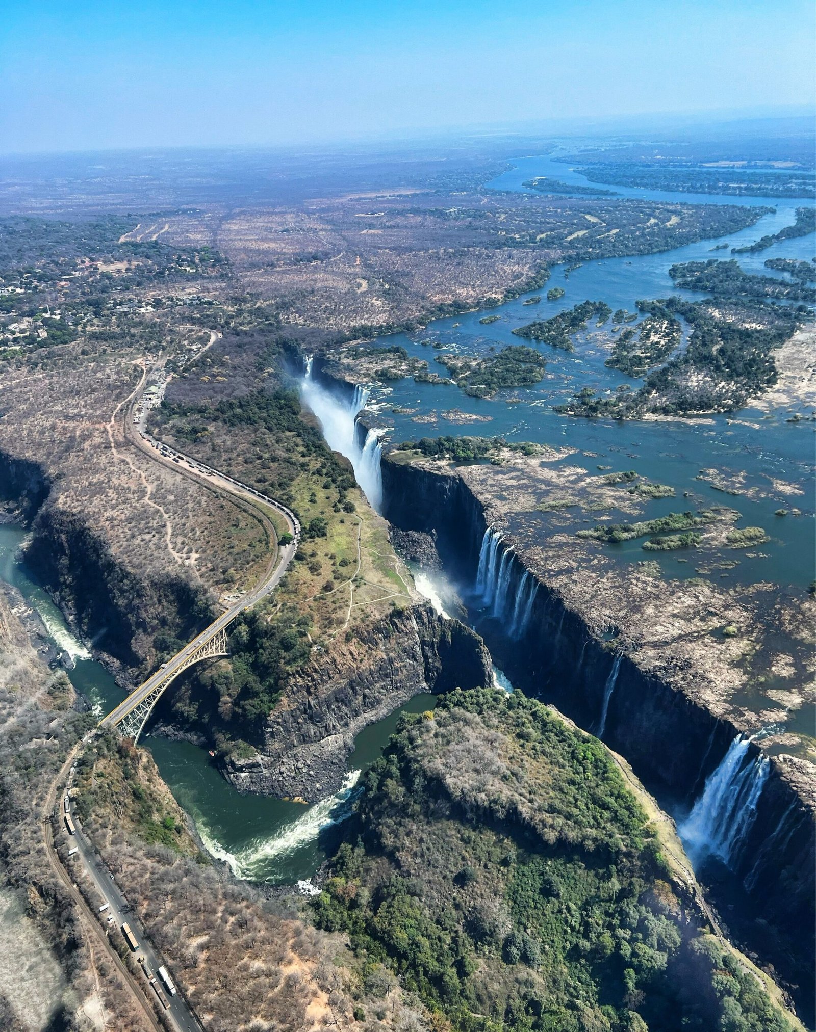 Aerial view of Victoria Falls showing the curtain of water and rising mist